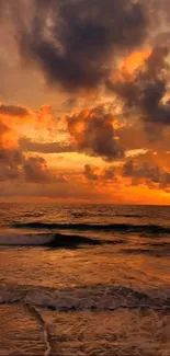 Orange sunset over ocean with clouds and waves.