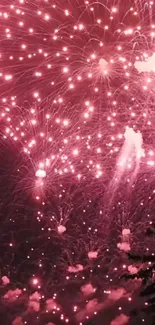 Pink fireworks lighting up the night sky in a vibrant display.