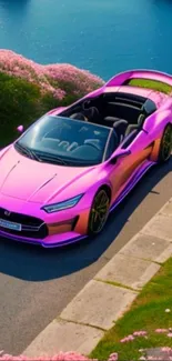 Vibrant pink sports car on scenic road with coastal view.