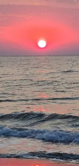 Vibrant pink sunset over ocean waves with a tranquil seascape.