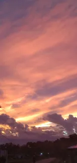 Serene pink sunset sky with clouds and evening colors.