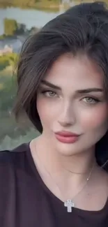 Portrait of a woman with a serene outdoor background.