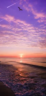 Purple sunset over ocean waves with a tranquil beach scene.