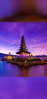 Purple temple by the lake at sunset, serene landscape.