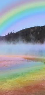 Vibrant rainbow arching over a serene lake landscape with mist.