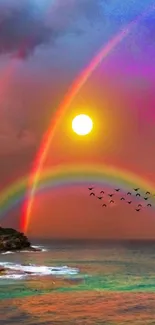 A vibrant double rainbow over the ocean at sunset with birds flying.