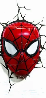 Red mask with web design breaking through a wall.