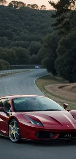 Red sports car on scenic winding road at sunset