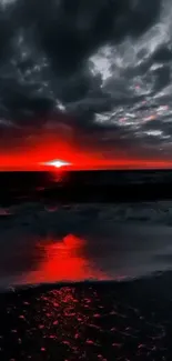 Vibrant red sunset over a tranquil beach scene.