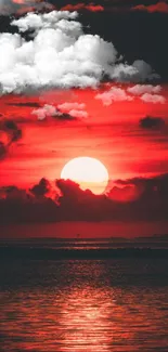 Vibrant red sunset over calm ocean waves.