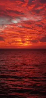 Beautiful red sunset over the ocean, with vibrant clouds and serene waters.