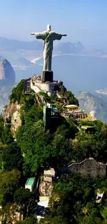 Christ the Redeemer with lush landscape of Rio de Janeiro.