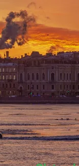 Scenic sunset over river with historic buildings in the background.