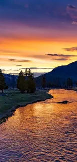 Vibrant sunset over a tranquil river landscape with scenic mountain views.