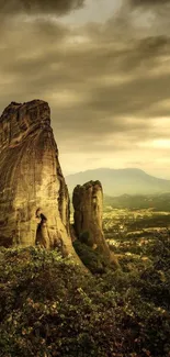 Dramatic rock formations under a cloudy sky with lush trees in foreground.