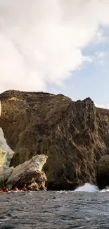 Rocky coastline with dramatic cliffs and serene sea under a bright blue sky.