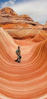 Person standing on stunning sandstone wave landscape.