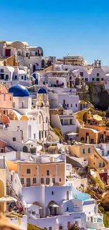 Santorini hillside with iconic white buildings and blue domes.