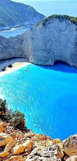 A stunning seaside cliff with bright blue waters and green cliffs.