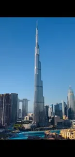 Tall skyscraper with blue sky and cityscape background.