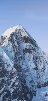 Snowy mountain peak under a clear blue sky.