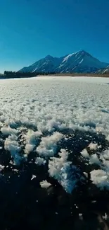 Snowy mountain landscape under a clear blue sky.