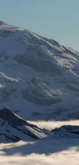 Snow-covered mountain with serene sky.