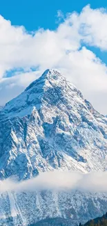 Snowy mountain landscape with blue skies and white clouds.