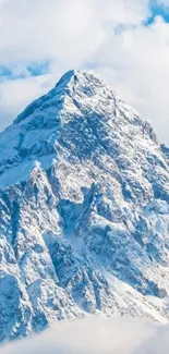 Snowy mountain peak against a bright blue sky background.