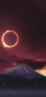 Solar eclipse over mountain with dark sky.