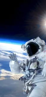 Astronaut floating in space above Earth with sunlit background.