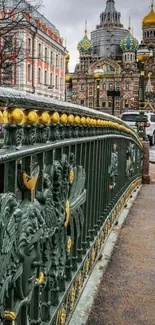 Cityscape with a historic cathedral and ornate bridge.