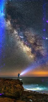 Person stargazing beneath a vibrant starry sky with Milky Way over an ocean horizon.