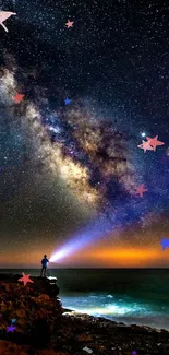 Person gazing at a star-filled galaxy night sky over the ocean.