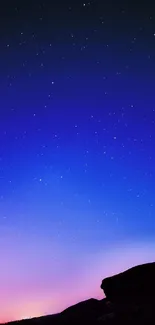 Starry night sky with twilight gradient and silhouette.