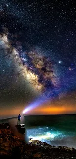 Person beneath starry sky at ocean with Milky Way.