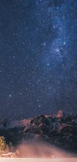 Starry night sky over misty mountains wallpaper.