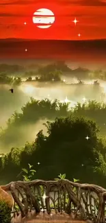 Bright sunrise over misty forest landscape with a wooden railing in foreground.