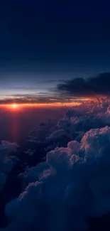 A breathtaking sunset above clouds with dark blue sky.