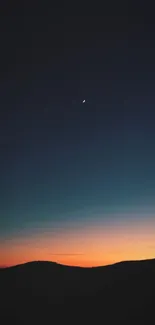 Vibrant sunset with a crescent moon over mountains.