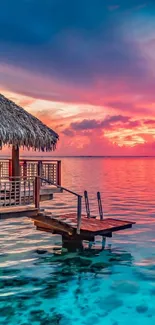 Tropical sunset overwater bungalow with pink skies.