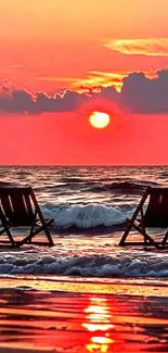 Sunset beach scene with empty chairs facing the ocean waves.