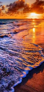 Stunning beach sunset with waves and vibrant orange sky.