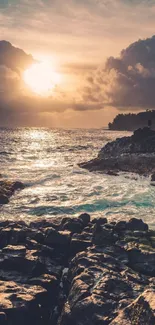 Stunning sunset over a rocky beach with ocean waves.