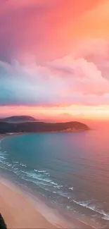 Vibrant sunset beach with pink and orange sky and calm ocean waves.