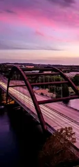 A picturesque bridge at sunset with vibrant skies reflecting on calm water.