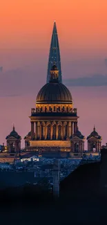 Majestic cityscape at sunset with glowing orange sky and detailed architecture.