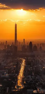 Dramatic sunset over a city skyline with tall buildings and orange hues.