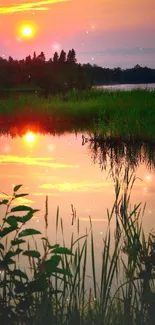 Sunset reflecting over tranquil lake with greenery