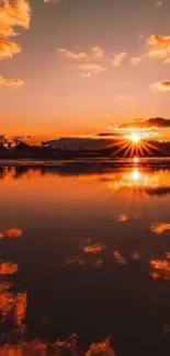 A breathtaking orange sunset reflecting over a calm lake with vibrant clouds.